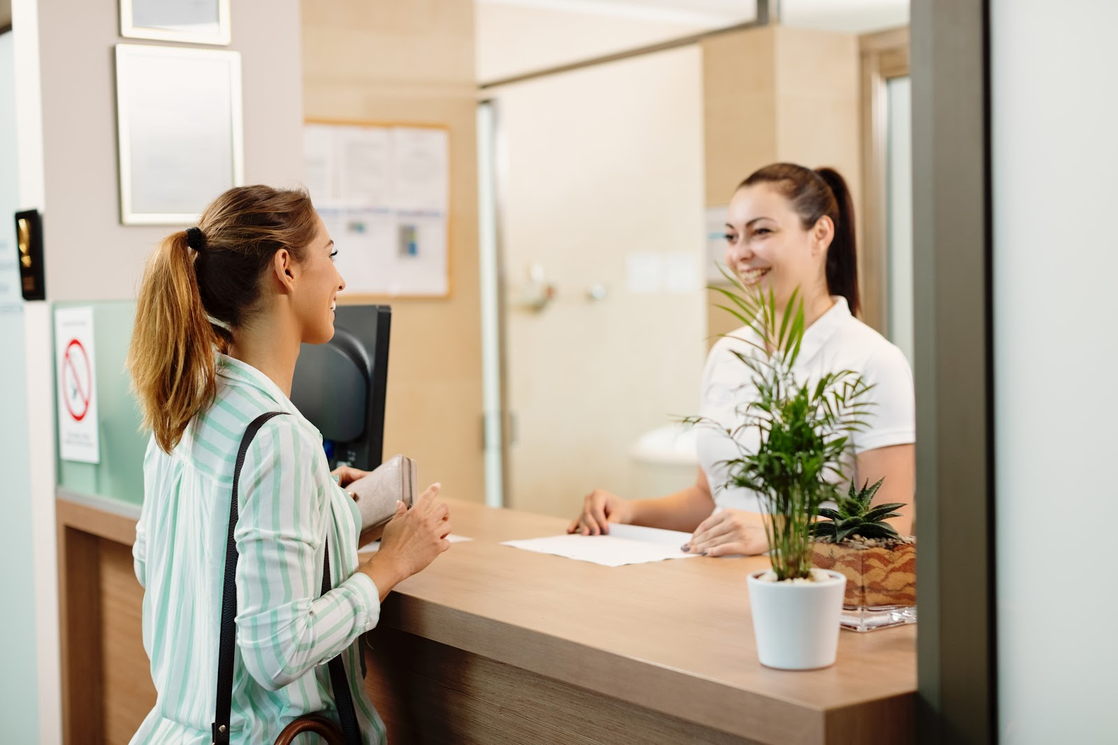 Visitor checking in at the front desk