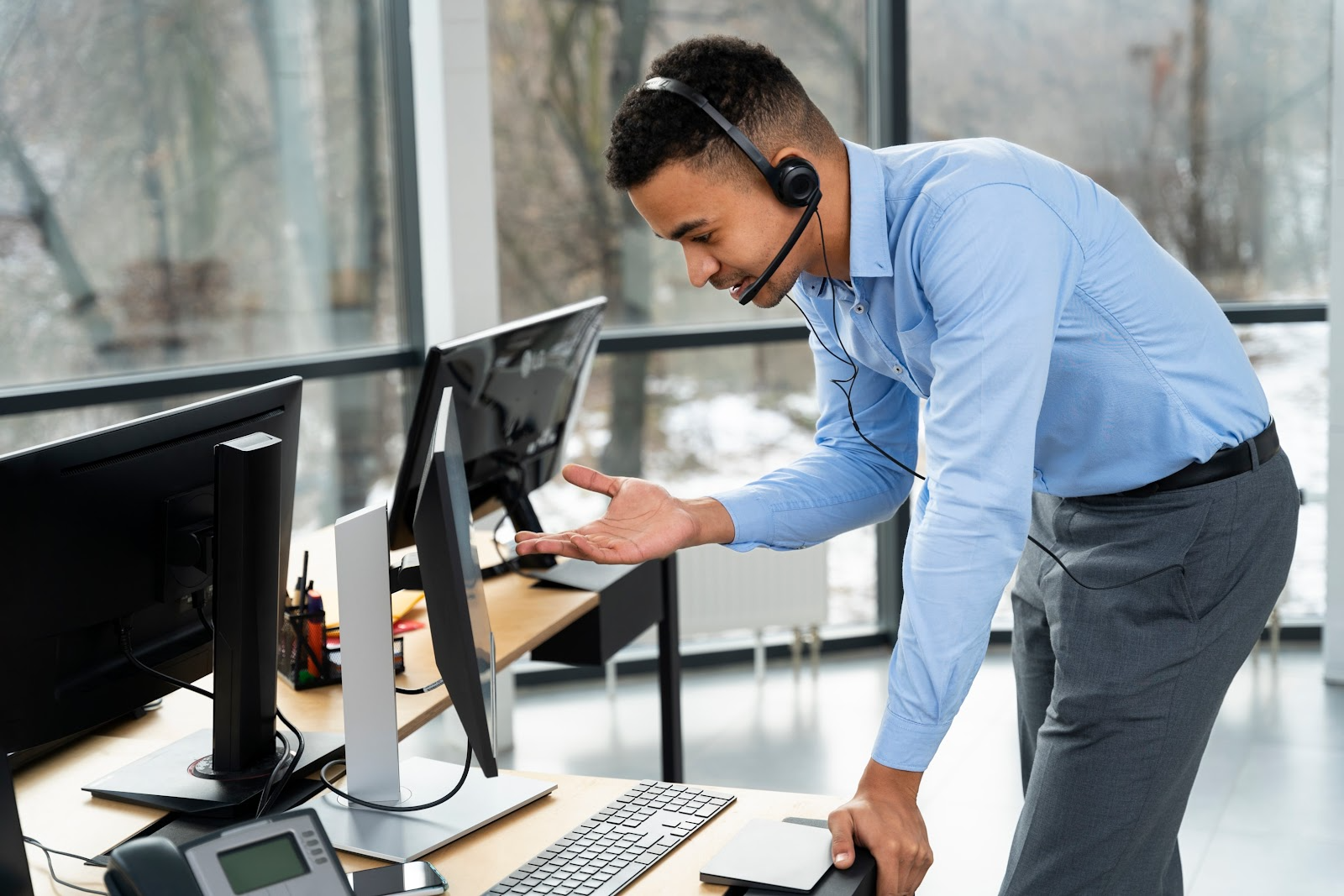 A man talking on a computer