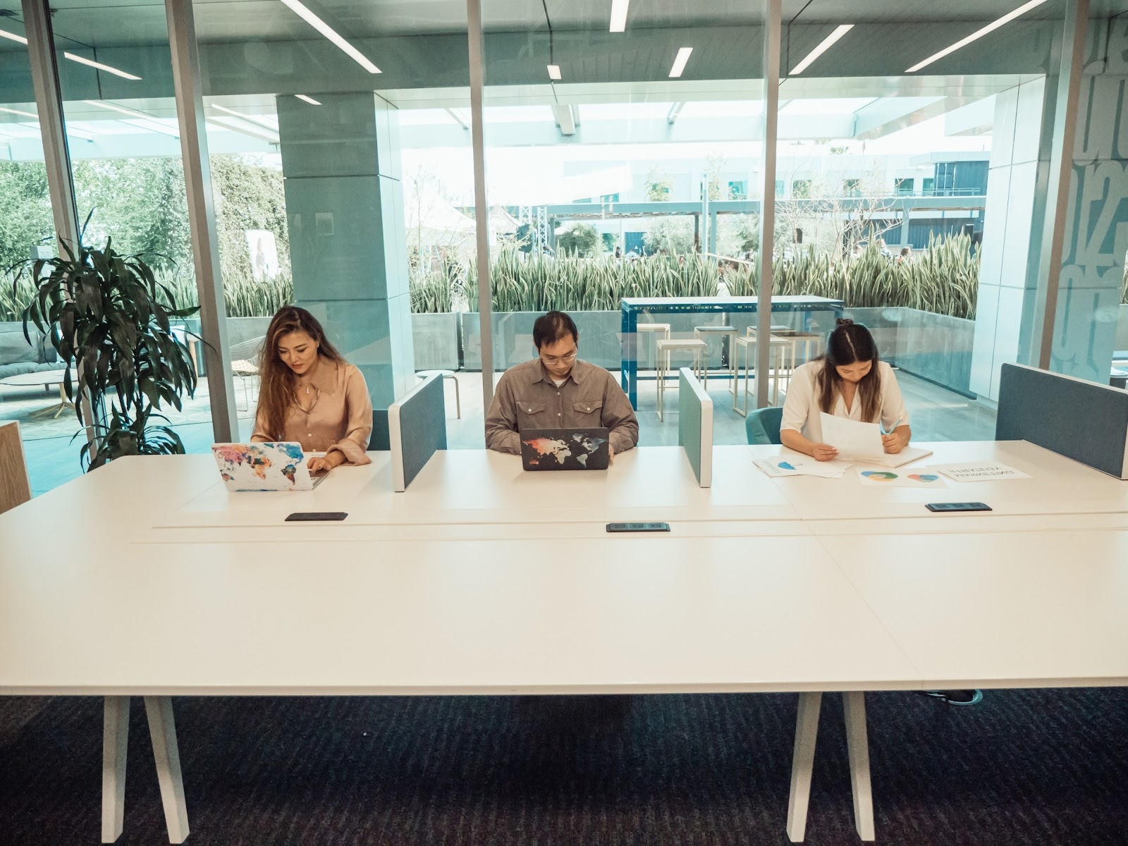 Three colleagues sharing a desk