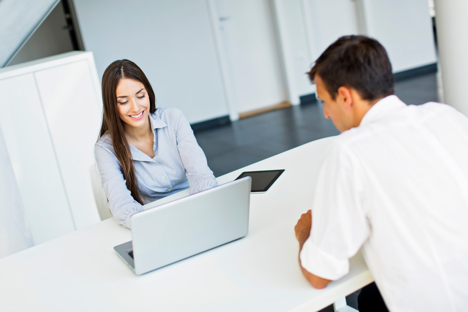 Woman checking her laptop for a visitor