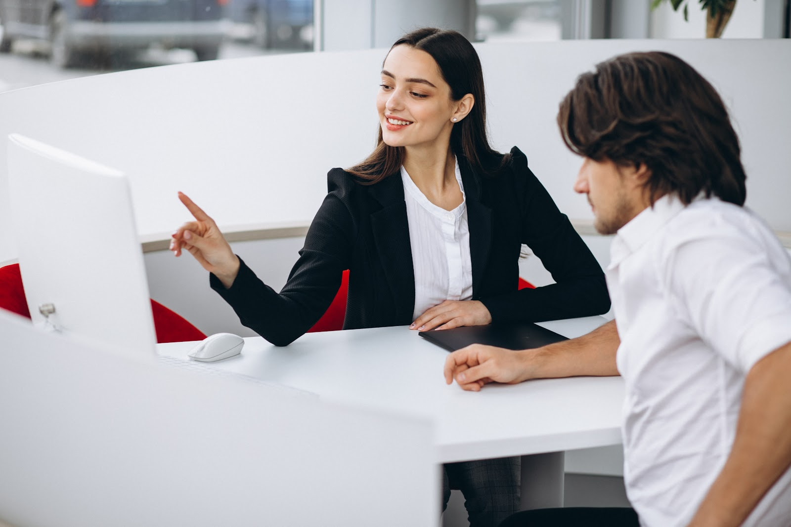 Woman showing her monitor to a customer