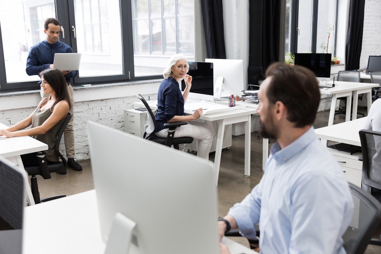 Colleagues talking in office